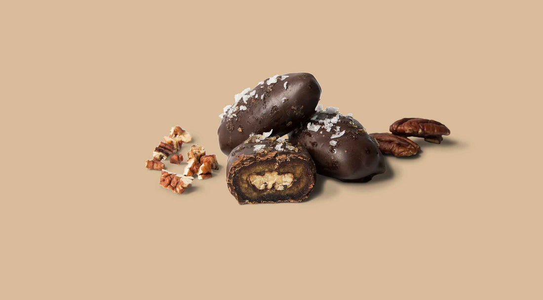 Chocolate-covered treats with nuts on a beige background